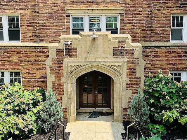 doorway to property with brick siding and french doors