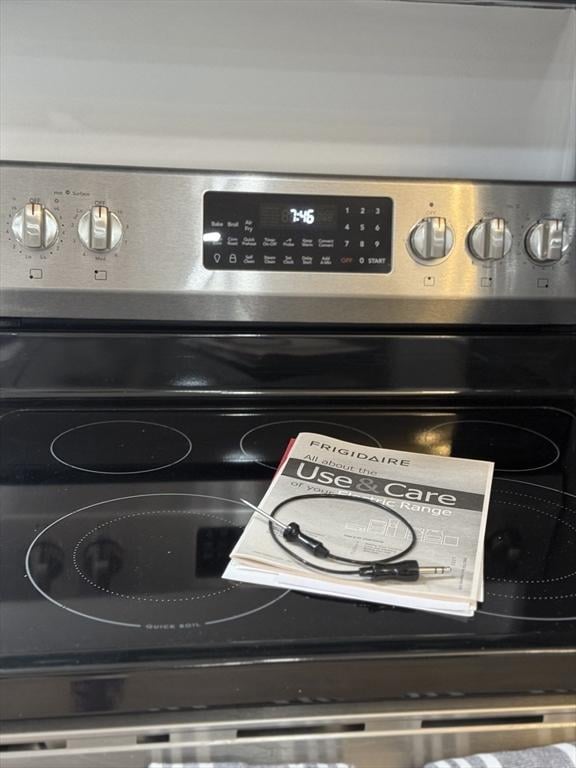 details with mail area and stainless steel range with electric cooktop