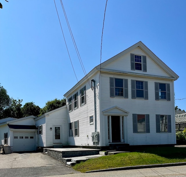 view of front of home featuring a garage and a front lawn