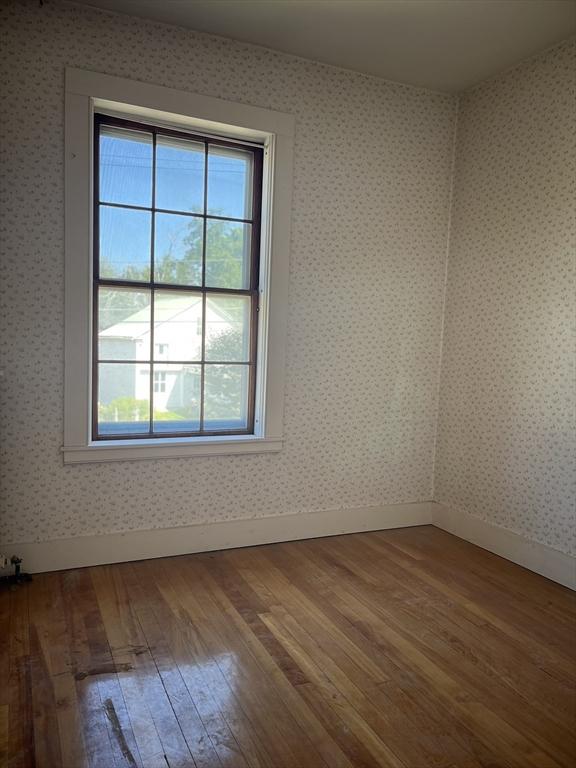 unfurnished room with hardwood / wood-style floors