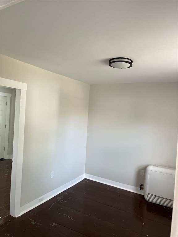 unfurnished room featuring dark hardwood / wood-style floors