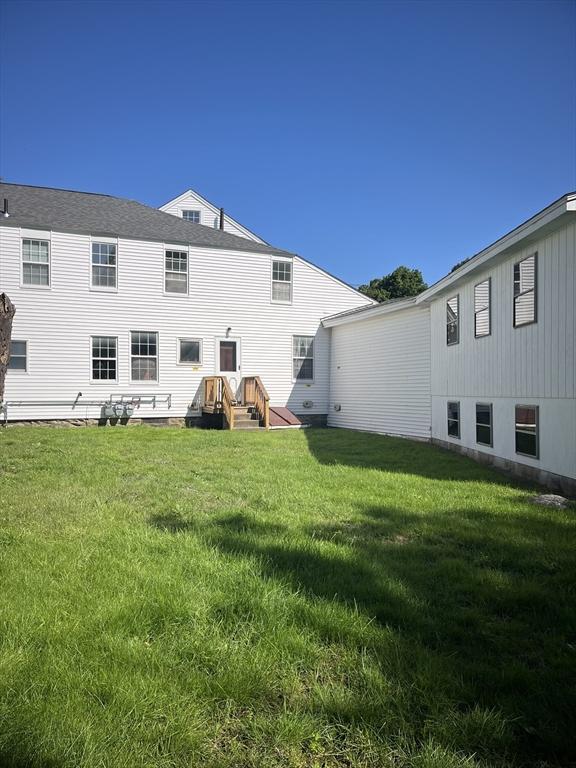 rear view of house with a yard