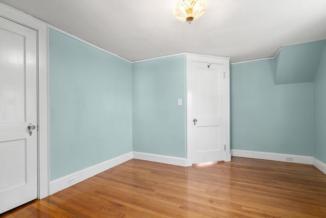additional living space with light wood-style floors and baseboards