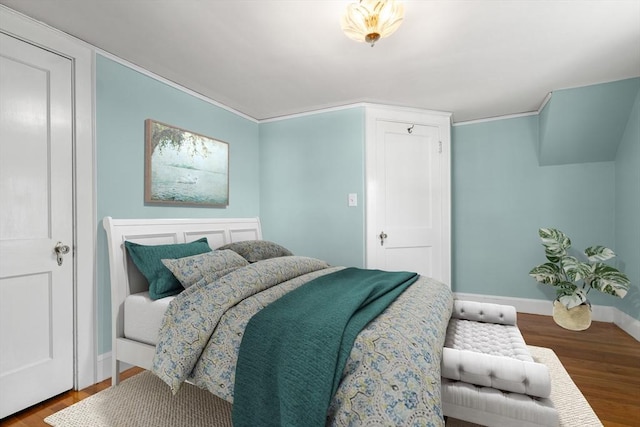 bedroom with baseboards and wood finished floors