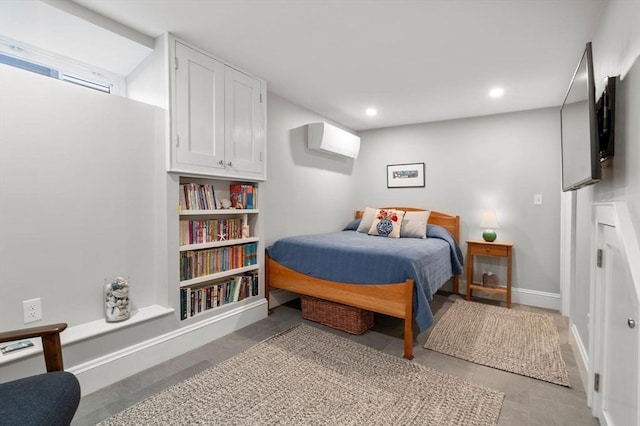 bedroom with baseboards, a wall unit AC, and recessed lighting