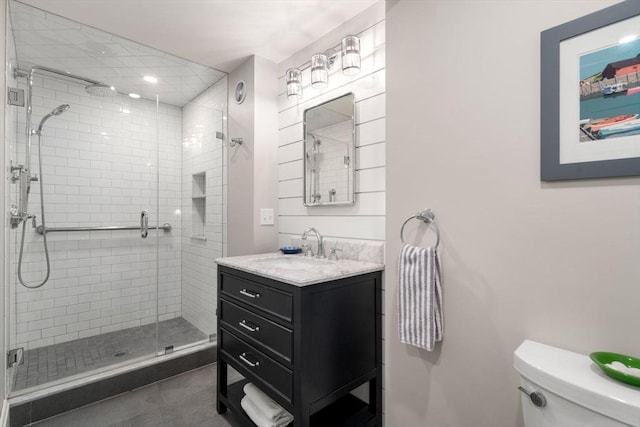 bathroom with vanity, tile patterned flooring, toilet, and a shower stall