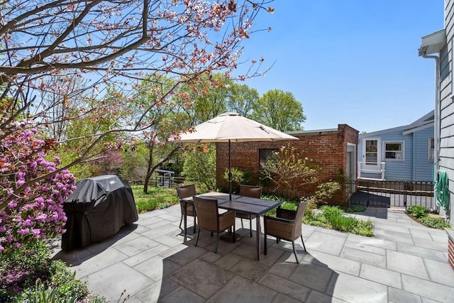 view of patio / terrace with fence, grilling area, and outdoor dining space