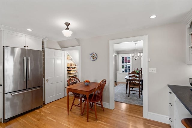 dining room with recessed lighting, baseboards, a chandelier, and light wood-type flooring