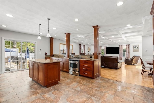 2 Dana Dr, Groveland, MA 01834 - kitchen featuring stainless steel range with gas cooktop, decorative columns, open floor plan, recessed lighting, and light stone countertops