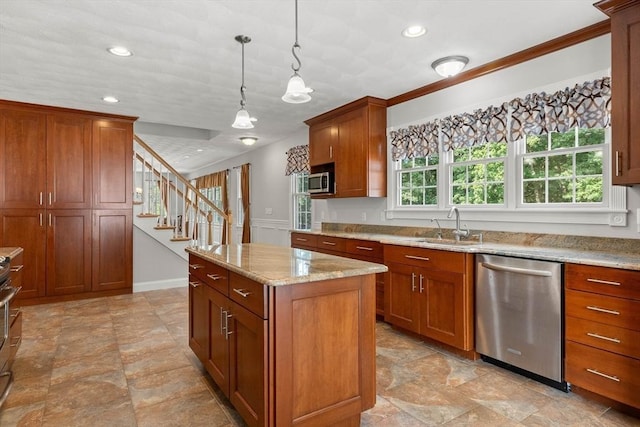 2 Dana Dr, Groveland, MA 01834 - kitchen with stainless steel appliances, a kitchen island, brown cabinetry, a sink, and light stone counters