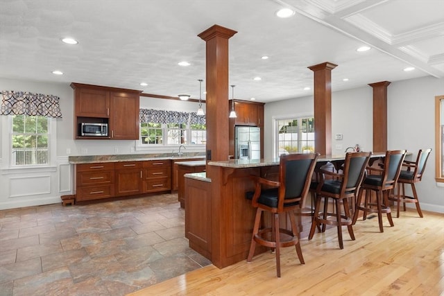 2 Dana Dr, Groveland, MA 01834 - kitchen featuring stainless steel appliances, ornate columns, a breakfast bar, recessed lighting, and light stone counters