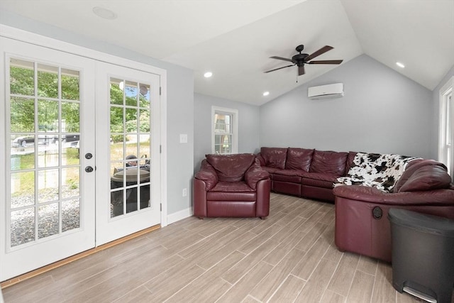 2 Dana Dr, Groveland, MA 01834 - living room featuring a wall unit AC, vaulted ceiling, french doors, light wood finished floors, and ceiling fan