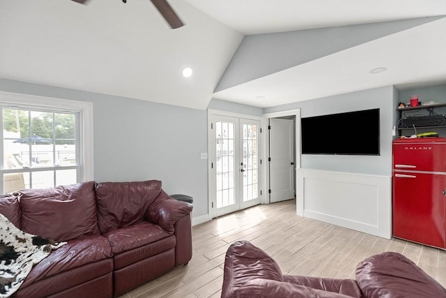 2 Dana Dr, Groveland, MA 01834 - living room with french doors, light wood-style flooring, vaulted ceiling, ceiling fan, and wainscoting