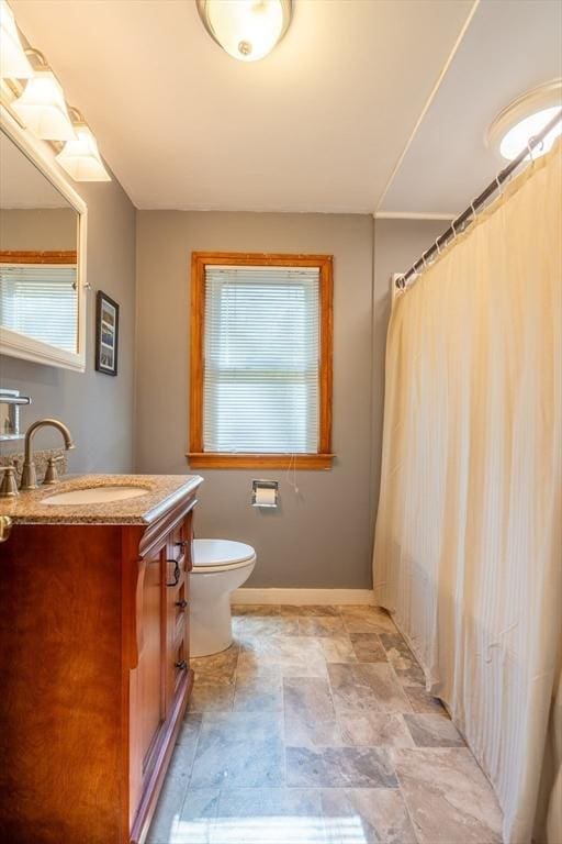 60 Highland Ave, Leominster, MA 01453 - full bathroom featuring plenty of natural light, stone finish floors, toilet, and vanity