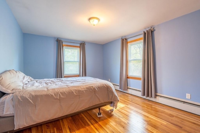 60 Highland Ave, Leominster, MA 01453 - bedroom with wood finished floors and a baseboard radiator