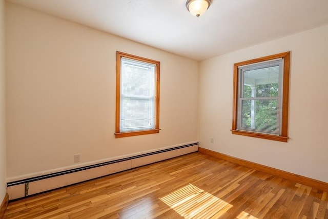 60 Highland Ave, Leominster, MA 01453 - empty room featuring a baseboard heating unit, wood finished floors, and baseboards