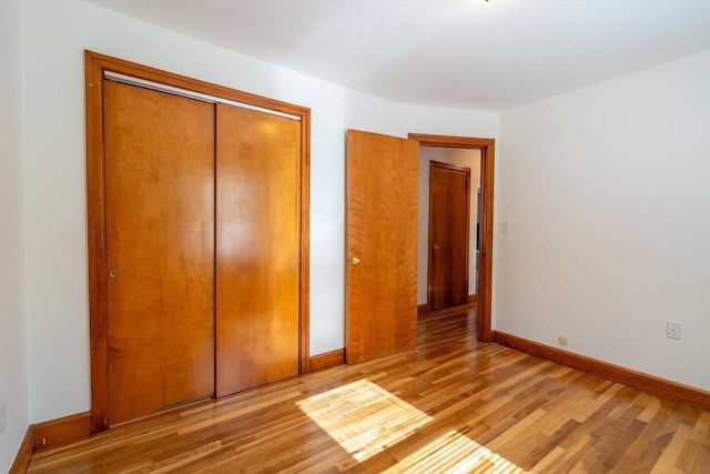 60 Highland Ave, Leominster, MA 01453 - unfurnished bedroom featuring light wood finished floors, a closet, and baseboards