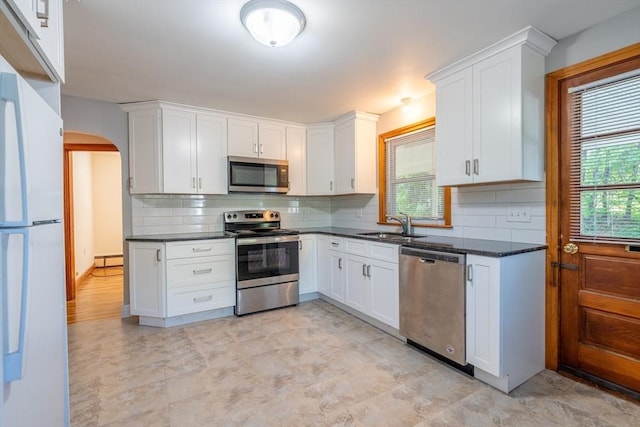 60 Highland Ave, Leominster, MA 01453 - kitchen featuring stainless steel appliances, a sink, plenty of natural light, and arched walkways