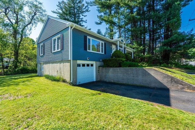 60 Highland Ave, Leominster, MA 01453 - view of side of home with asphalt driveway, a yard, and an attached garage