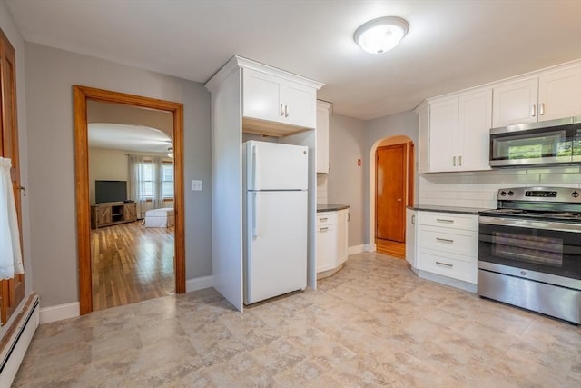 60 Highland Ave, Leominster, MA 01453 - kitchen featuring appliances with stainless steel finishes, arched walkways, a baseboard radiator, dark countertops, and white cabinets