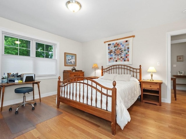 83 Boynton St, Waltham, MA 02453 - bedroom with wood finished floors, a desk, and baseboards