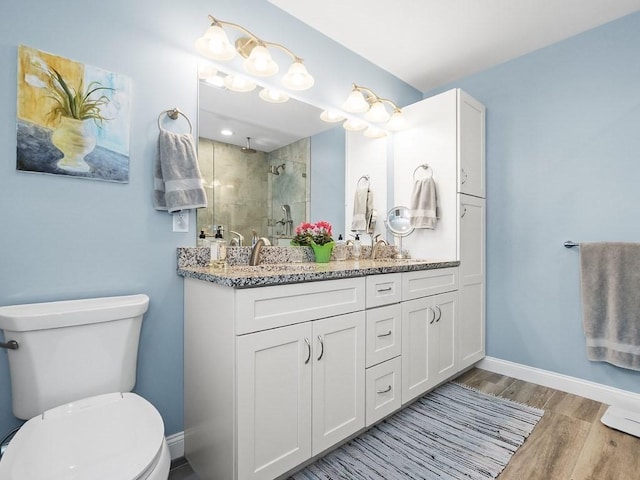 83 Boynton St, Waltham, MA 02453 - bathroom featuring toilet, a tile shower, wood finished floors, baseboards, and vanity