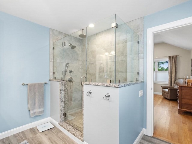 83 Boynton St, Waltham, MA 02453 - full bath with a stall shower, wood finished floors, baseboards, and vaulted ceiling