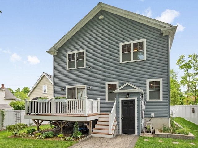 83 Boynton St, Waltham, MA 02453 - rear view of house with a wooden deck and fence