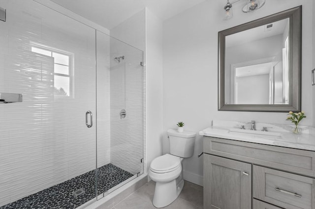 bathroom with baseboards, vanity, toilet, and a shower stall