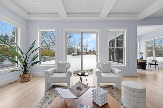 sunroom / solarium with a healthy amount of sunlight and beamed ceiling