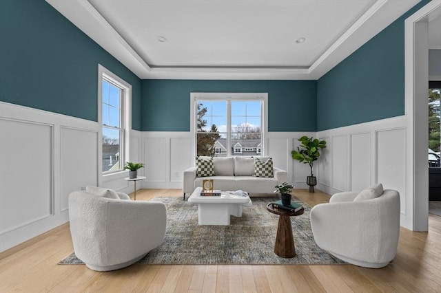 sitting room with a wainscoted wall, wood finished floors, and a decorative wall