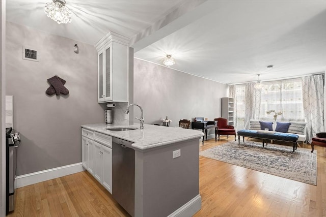 42 8th St Unit 4106, Boston, MA 02129 - kitchen featuring a sink, stainless steel appliances, open floor plan, white cabinets, and light wood-type flooring