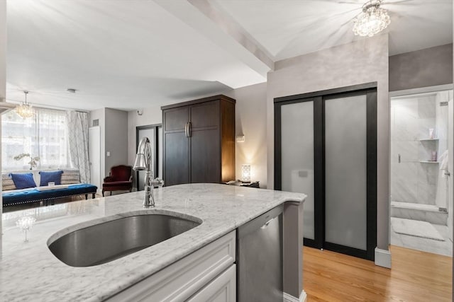 42 8th St Unit 4106, Boston, MA 02129 - kitchen with dishwasher, a sink, light wood-style flooring, light stone countertops, and a chandelier