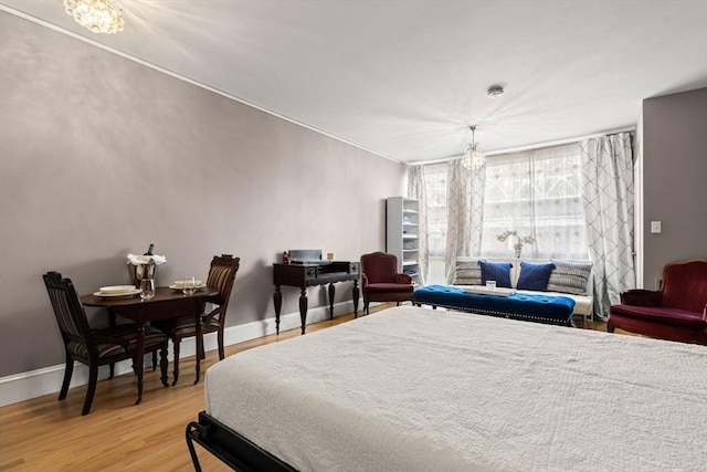 42 8th St Unit 4106, Boston, MA 02129 - bedroom featuring a chandelier, baseboards, and light wood finished floors