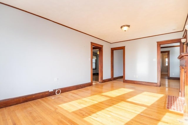 unfurnished bedroom featuring crown molding, baseboards, and wood finished floors