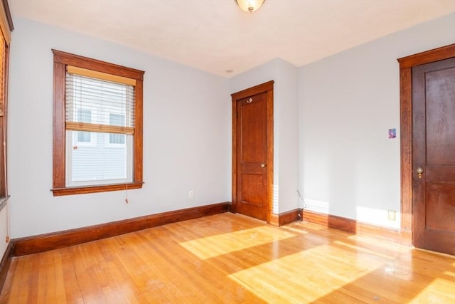 unfurnished room featuring baseboards and wood finished floors