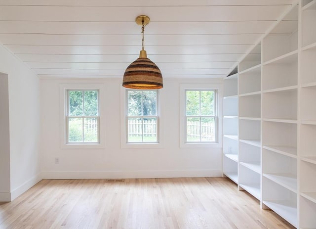 empty room with wooden ceiling, light hardwood / wood-style floors, and vaulted ceiling