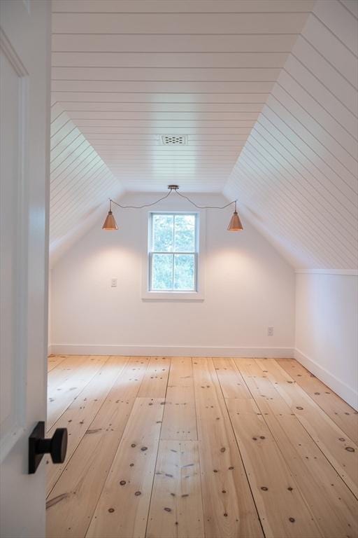 bonus room with hardwood / wood-style flooring and lofted ceiling