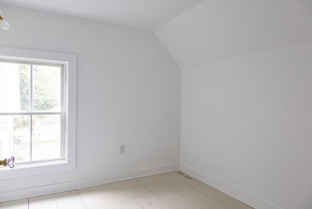 additional living space featuring vaulted ceiling