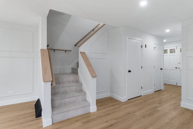 stairs featuring hardwood / wood-style flooring