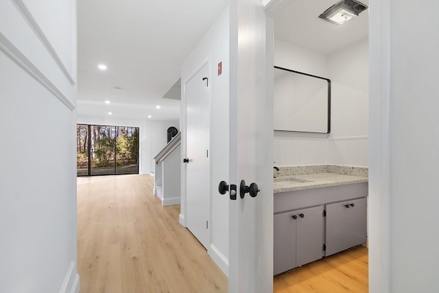 hall featuring light wood-type flooring and sink