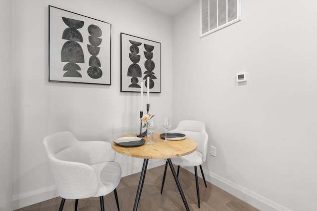 100 Lincoln St Unit 303, Boston, MA 02135 - dining space featuring baseboards and wood finished floors