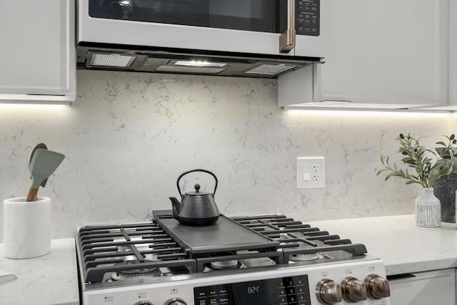 100 Lincoln St Unit 303, Boston, MA 02135 - kitchen with stainless steel microwave, range, white cabinets, and light stone counters