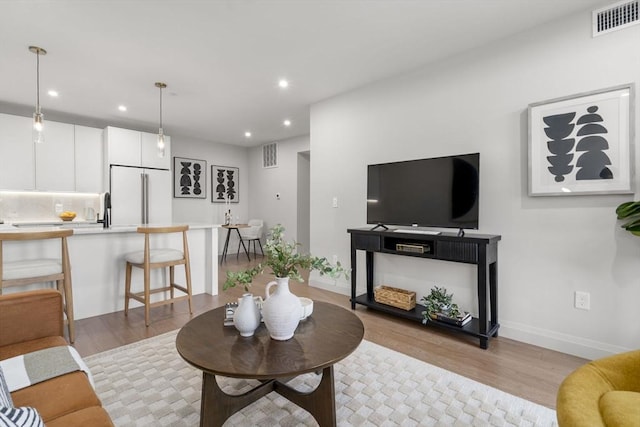 100 Lincoln St Unit 303, Boston, MA 02135 - living area with light wood-style flooring and recessed lighting