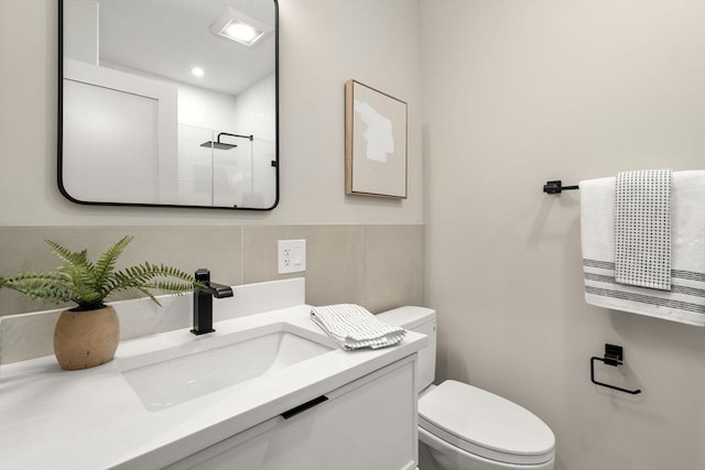 100 Lincoln St Unit 303, Boston, MA 02135 - bathroom with a tile shower, vanity, and tile walls