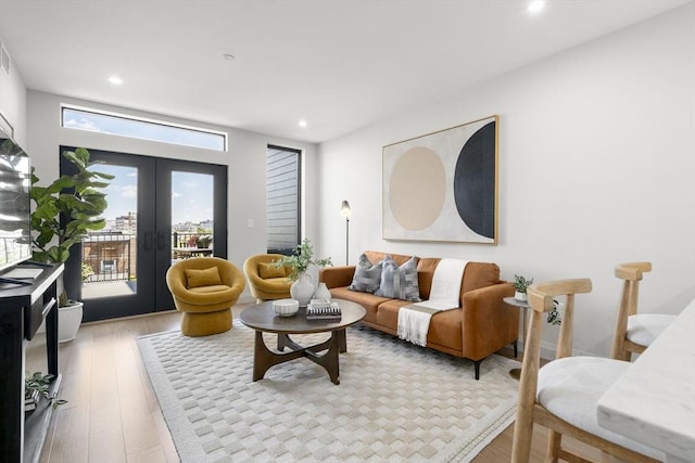 100 Lincoln St Unit 303, Boston, MA 02135 - living area with recessed lighting, french doors, and light wood-style floors