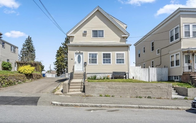 shotgun-style home featuring fence