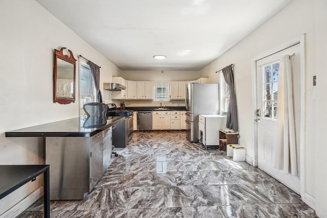 kitchen with a sink, dark countertops, and stainless steel appliances