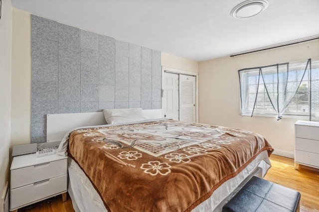 bedroom with a closet and wood finished floors