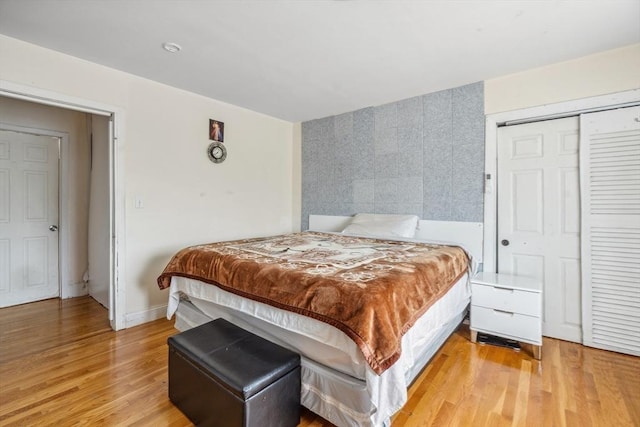 bedroom with light wood-style floors and a closet